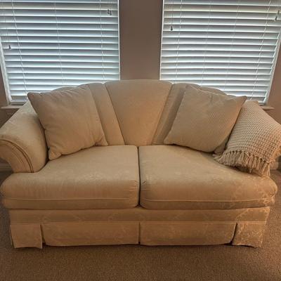 Cute Cream Sofa With Pillows And Throw Blanket