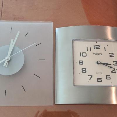 Two Battery Operated Wall Clocks -- Stainless Steel And Glass