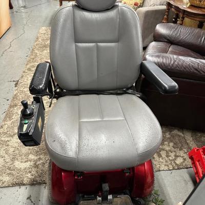 Two motorized mobility scooters. 