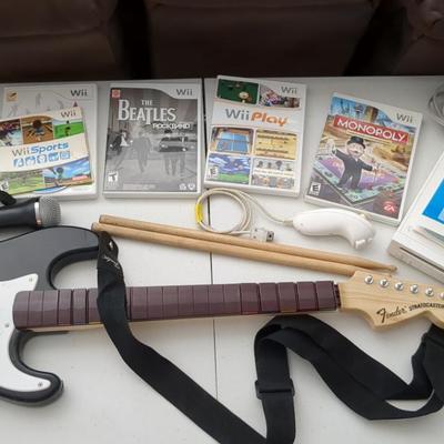 Nintendo Wii Video Game Console with Games and Music Accessories (Guitar, Drumsticks, Microphone)