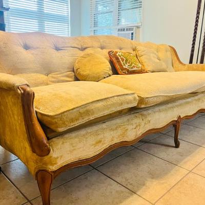 Mid-Century Modern yellow  three-seater sofa with button-tufted detailing, dating from the 1950s to 1970s. 