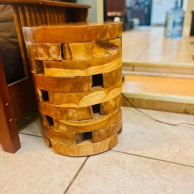 Southeast Asia decorative side table constructed from stacked wood slices. Emphasizes natural materials & minimalist forms. 