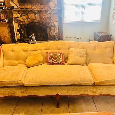 Mid-Century Modern yellow  three-seater sofa with button-tufted detailing, dating from the 1950s to 1970s. 