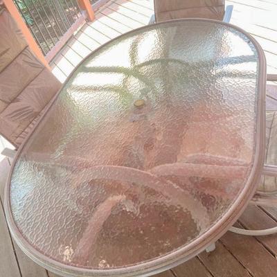 Outdoor glass top with metal base dining table, with 4 swivel/rocking chairs 