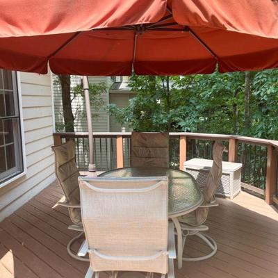 Outdoor glass top with metal base dining table, with 4 swivel/rocking chairs 