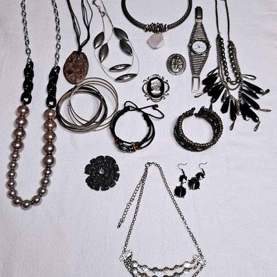 Silver tone and black fashion jewelry. 