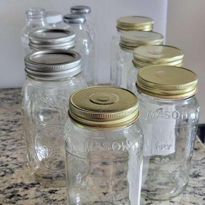 Assorted glass bottles and jars featuring Ball and Mason