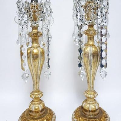 1127	PAIR OF ORNATE GILT WOOD CANDLSTICKS WITH GEOMETRIC AND TEAR DROP PRISMS, EACH APPROXIMATELY 27 IN H
