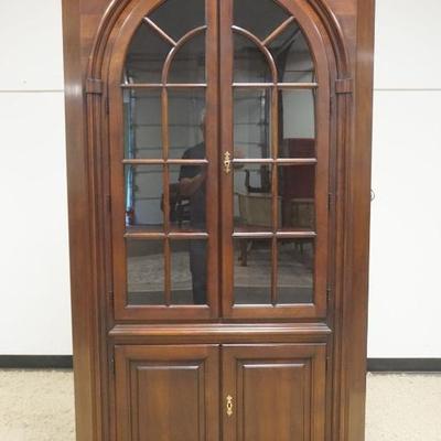 1217	STATTON BLACK CHERRY CORNER CABINET HAVING 4 DOORS, INTERIOR LIGHTING ON BRACKET FEET, SCALLOPED EDGE SHELVES, APPROXIMATELY 44 IN X...