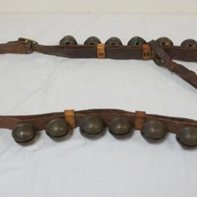 1073	BRASS SLEIGH BELLS, 20 MOUNTED ON LEATHER STRAP, BELLS APPROXIMATELY 2 1/2 IN
