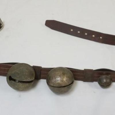 1072	BRASS SLEIGH BELLS, 6 MOUNTED ON LEATHER STRAP, LARGEST APPROXIMATELY 3 1/2 IN
