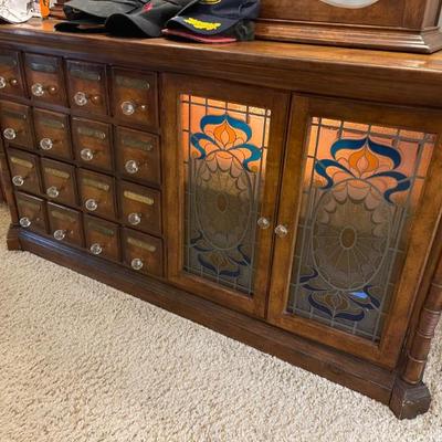 Matching dresser has stained glass and apothecary drawers 