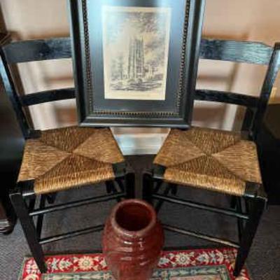 Pair of chairs with art rug