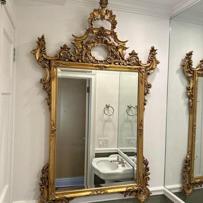 Louis XV Style Ornate Wall Mirror | Vintage (late 20th c.) Louis XV style ornate giltwood wall mirror with beveled glass edge. After...