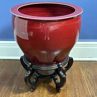 Chinese Oxblood-Colored Fishbowl - 2/2 | Chinese oxblood/deep red porcelain fishbowl/cachepot with wooden stand. Stand: h. 8”. Cachepot:...