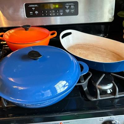 (3pc) Cookware - Le Creuset & Copco | Modern (contemporary) Le Creuset enameled cast iron dutch oven with lid in "Flame"...