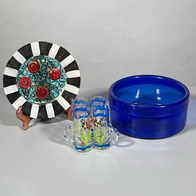 (6pc) Painted Glass Pieces And Bowl | Low glass blue bowl, hand painted plate and four cordial shot glasses. Dimensions: h. 3.5 x dia. 8...