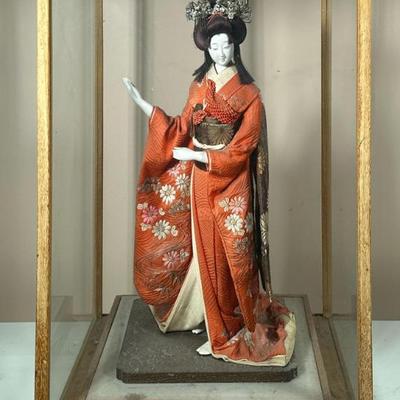 Geisha Doll | Porcelain statue with traditional kimono attire and wig in display case. Possibly a Nishi Doll, 18” tall. - h. 25 x w. 16 x...