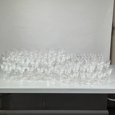 (87pc) HUGE LOT CRYSTAL/GLASSWARE | Including: 34 red wine glasses, 12 champagne glasses, 8 white wine glasses, 21 water goblets, and 12...