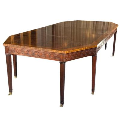 RALPH LAUREN / HENREDON CARVED WOOD DINING TABLE | Having burlwood veneer center with carved sides and brass casters; includes 2 22in...