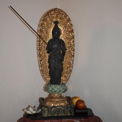 Hand carved wooden diety on pedestal 