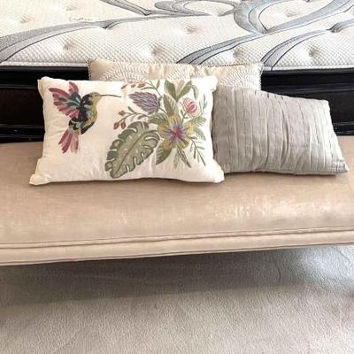 Upholstered bench with accent pillows