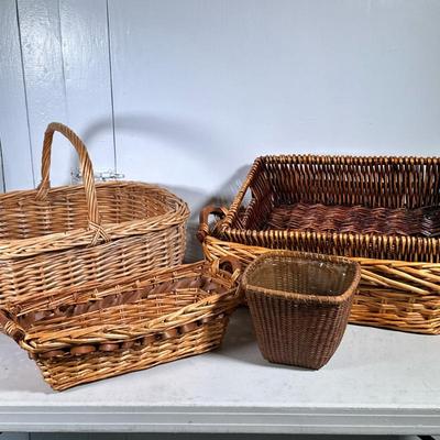 (5pc) Woven Baskets | One is lined for a planter and the other is oblong with two-tone weaves and wooden handles. - h. 16 x w. 15 x l....