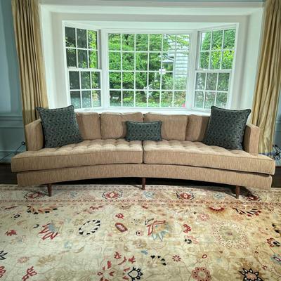 CURVED 2-CUSHION SOFA | Large curved 2-cushion sofa in the style of Edward Wormley or Harvey Prober. Button tufted seat; throw pillows...