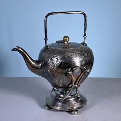 Silver Plated Tea Kettle | On stand with vessel for oil heating underneath. Numbered and marked on bottom. - h. 12 x w. 7 x l. 9 in
