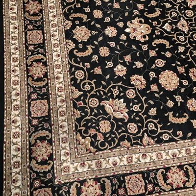 Black and ivory floral area rug with an ornate medallion and vine pattern.