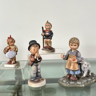(4pc) Goebel Hummels Figurines - "The Flutist" & Others | Collection of vintage Goebel Hummels figurines including: "O...