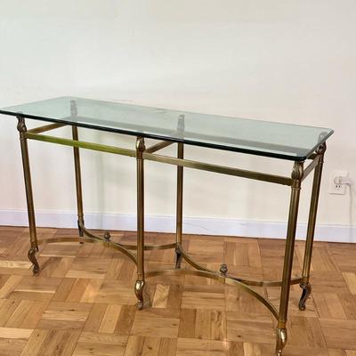 Regency Style Brass Console Table | Vintage (mid 20th c.) Regency style brass console table with glass top with decorative finials on...