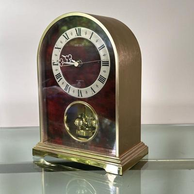 Seiko Brass Mantle Clock | Seiko mantle clock with an outer brass rim and wooden finish decor within the front of the clock. Contains a...