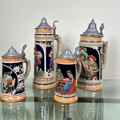(4pc) German Lidded Beer Steins/Mugs | Collection of vintage German ceramic/stoneware lidded beer steins, also known as Bierkrugs. Two...