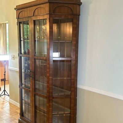 Tall Oak China/Curio Cabinet | Vintage (mid 20th c.) tall oak wood china/curio cabinet with four glass panels adorned with brass...