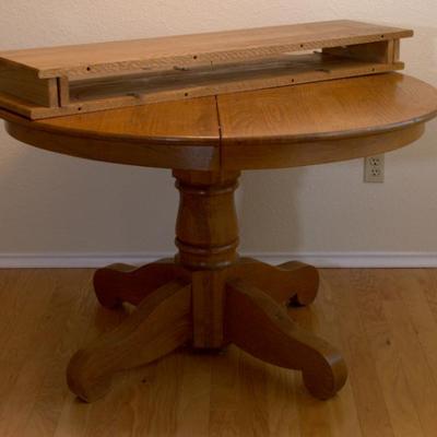 Sale Photo Thumbnail #5: 48" solid oak pedestal table with two leaves and four chairs $300 with chairs, $200 without chairs