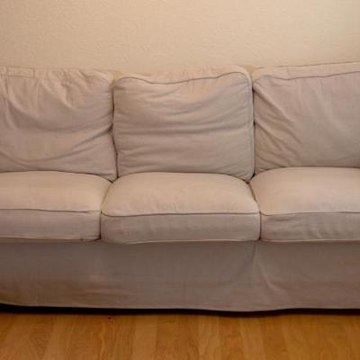 Ikea sofa $50.  Kids didn't fluff up the pillows before photographing sofa.  It looks better than this.