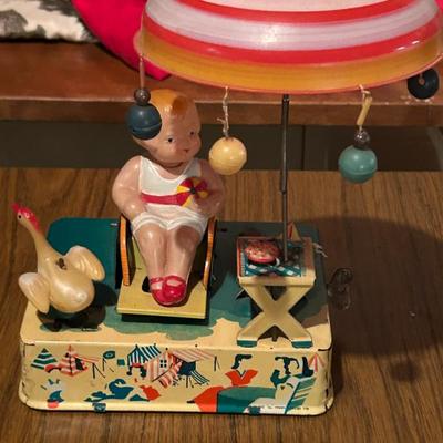 Tin Lithographed Windup Toy “Happy Life” Girl on Beach 