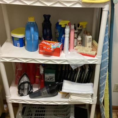 Small white shelf with cleaning supplies