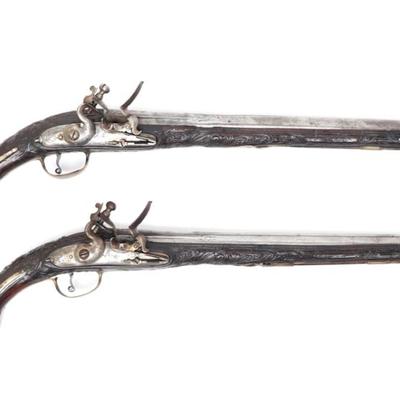 Lot 94 brace of ornate silver carved stock cavalry pistols, 18th c.