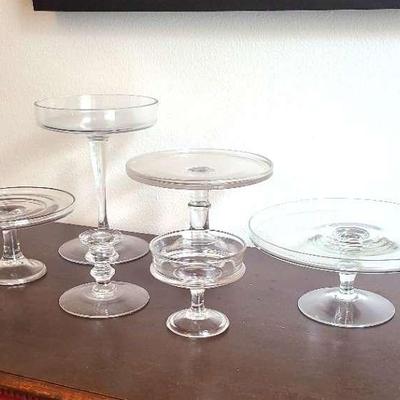 Assorted Glass Dessert Or Decor Stands And One Candlestick