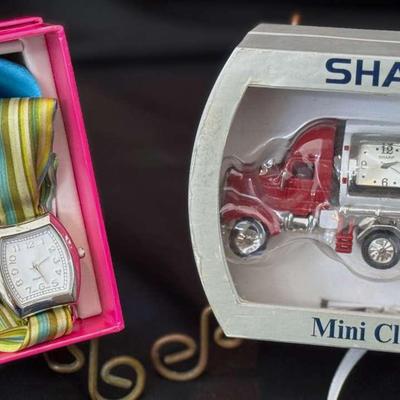 Lot 157: Clock On Mini Silver/Red Truck. Quartz Watch With Interchangeable Cloth Bracelets