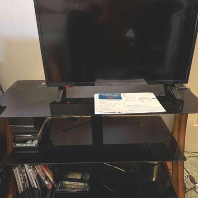 Lot 174: LED Insignia 32”TVCabinet, And DVD’s