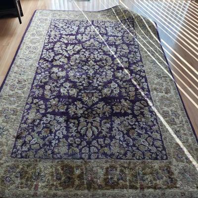 Area Rug with navy and plum floral patterns 