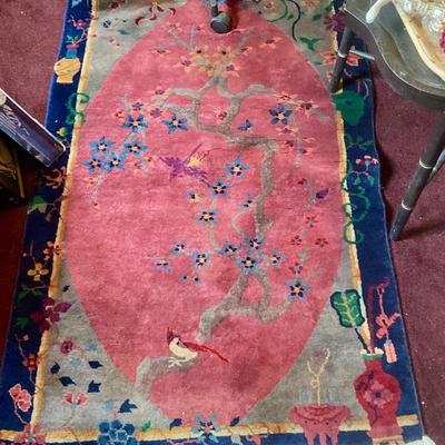 Art deco Chinese rug circa 1920’s, blue boarder, red center with tree birds and flowers. 35” x 56” in good or better condition