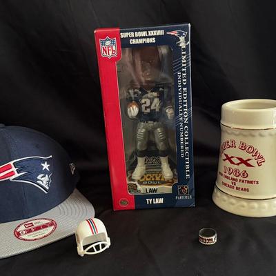 Lot 442: New England Patriots Collectible Lot – Ty Law Bobblehead, Snapback Hat, 1986 Mug, Ring & Mo