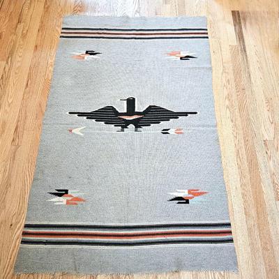  Handwoven wool rug featuring a central thunderbird motif, surrounded by arrow and bird forms 42" x 70"