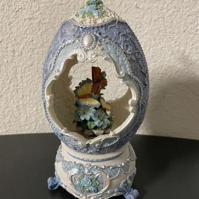 Ornamental Egg-Shaped Porcelain Figurine with Butterfly and Floral Motif