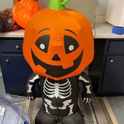 Halloween Decor With Light Up Pumpkins And Inflatable Pumpkin Man