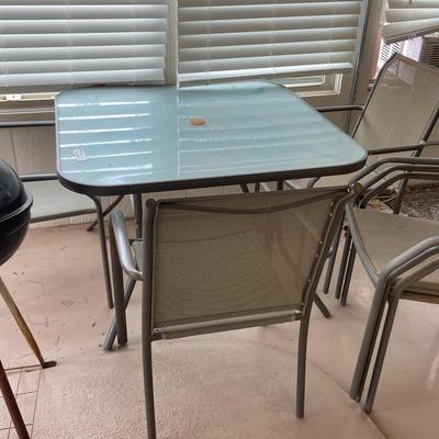 Outdoor Glass Top Table With Matching Chairs And Charcoal Grill